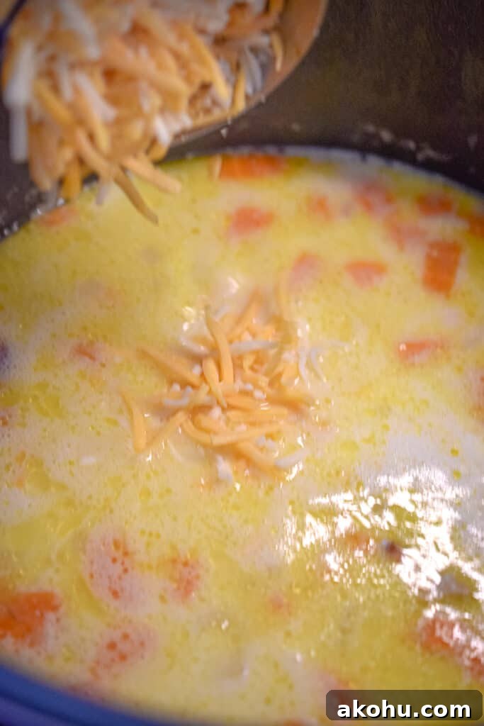 The cheese is added to the instant pot ham and potato soup