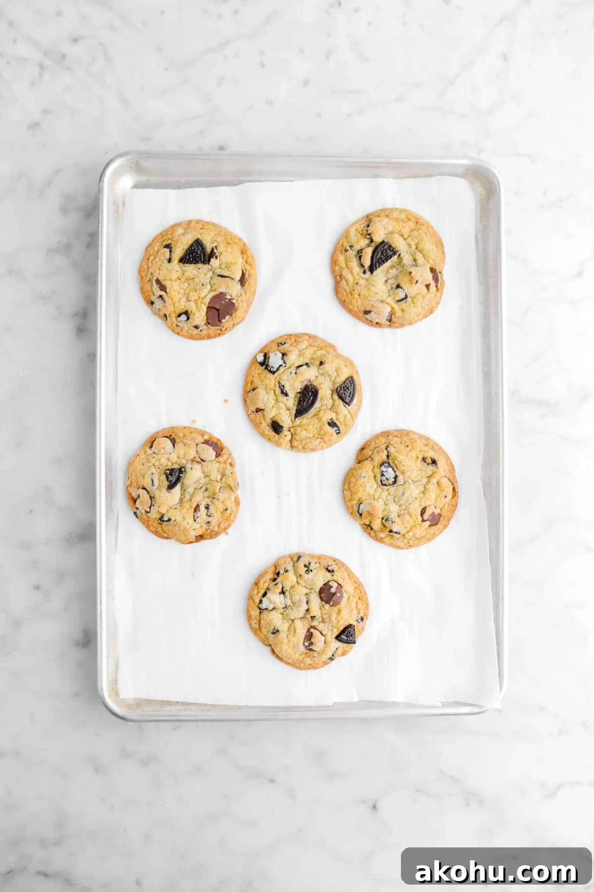 Oreo Stuffed Chocolate Chip Cookies: Gooey, Crunchy Dessert 9 six baked oreo chocolate chip cookies on lined sheet pan.
