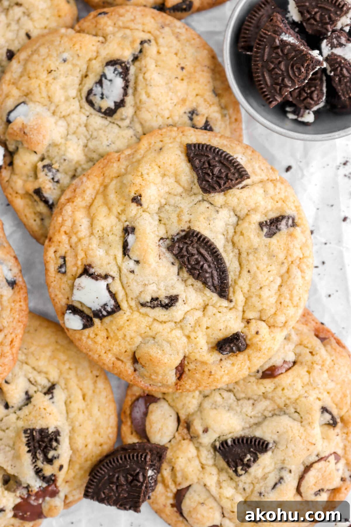 Oreo Stuffed Chocolate Chip Cookies: Gooey, Crunchy Dessert 10 overhead close up of oreo chocolate chip cookie piled on top of other cookies.
