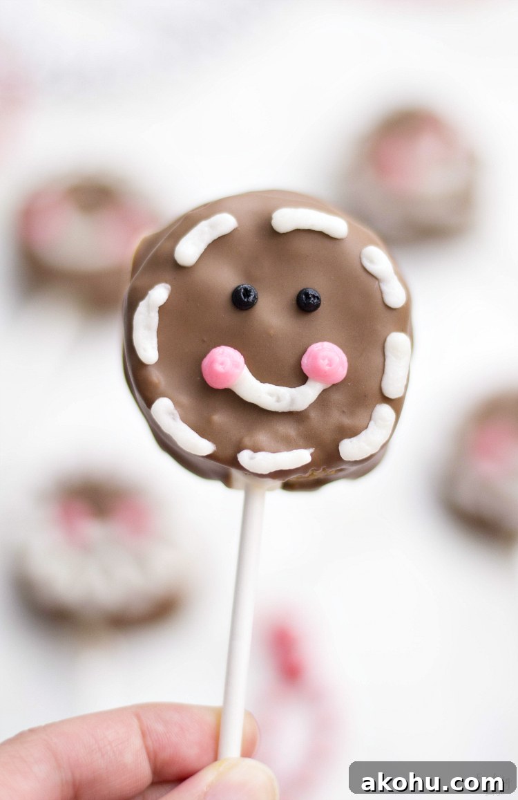 These gingerbread cake pops are sure to bring smiles this holiday season! Made from homemade gingerbread cake, these cake pops feature a sweet gingerbread man face that is as fun as it is delicious! This recipe makes a great Christmas dessert for all ages.