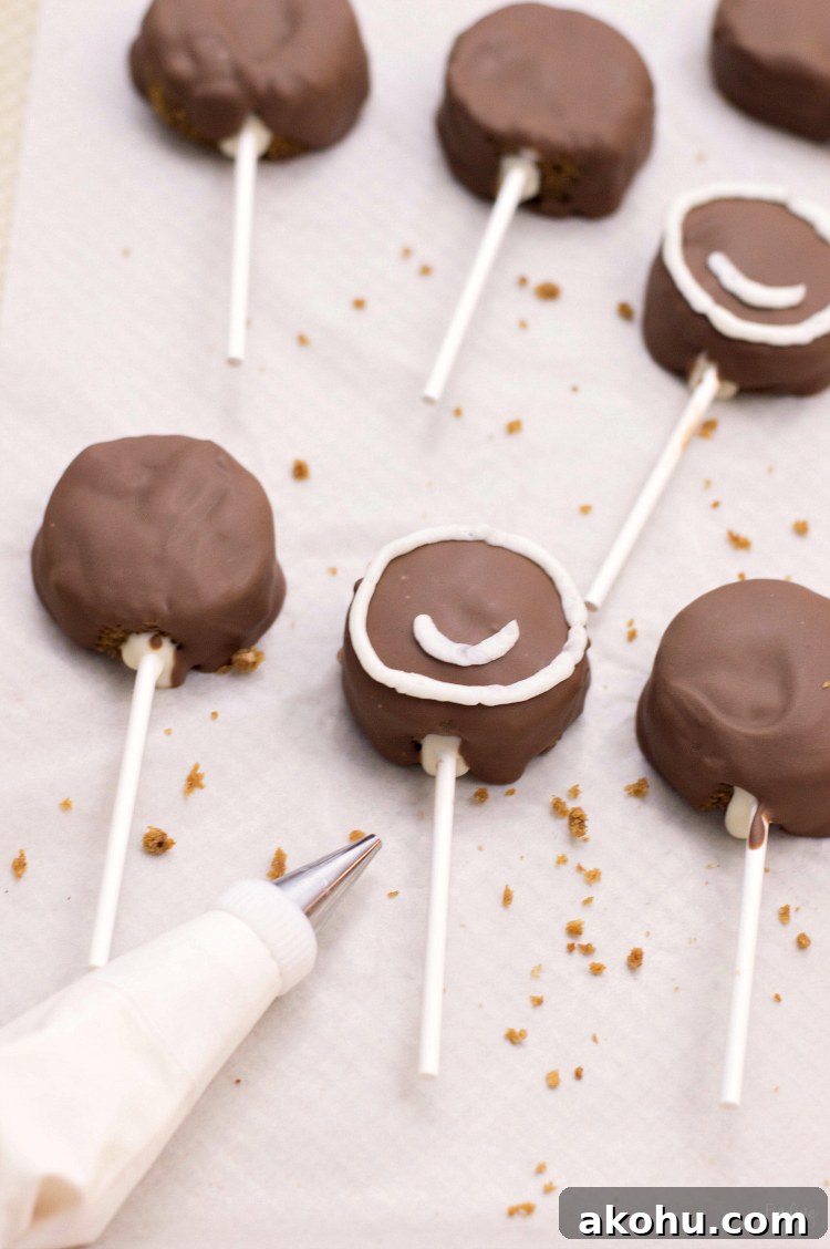 These gingerbread cake pops are sure to bring smiles this holiday season! Made from homemade gingerbread cake, these cake pops feature a sweet gingerbread man face that is as fun as it is delicious! This recipe makes a great Christmas dessert for all ages.