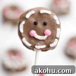 These gingerbread cake pops are sure to bring smiles this holiday season! Made from homemade gingerbread cake, these cake pops feature a sweet gingerbread man face that is as fun as it is delicious! This recipe makes a great Christmas dessert for all ages.