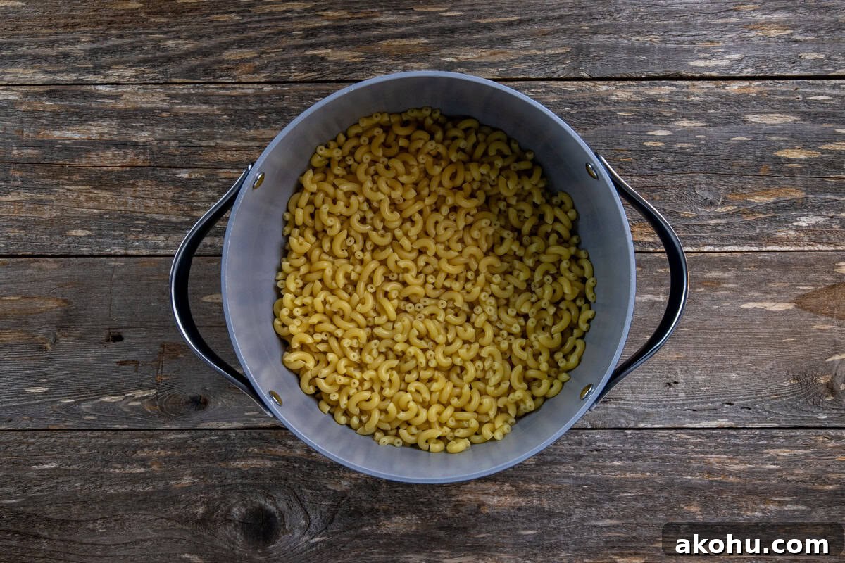 Cooked elbow macaroni in a large pot.
