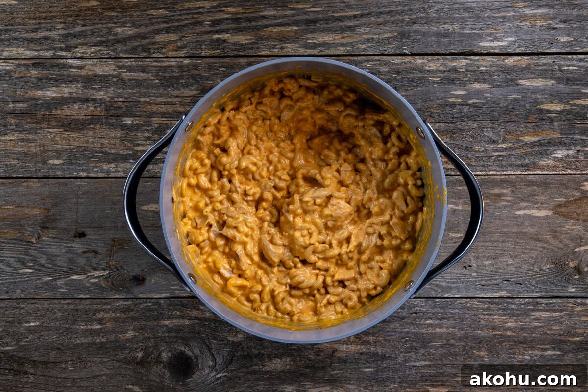 Cooked and diced chicken, Frank's Buffalo Sauce, ranch dressing, milk, and more cheddar cheese added to the pot.