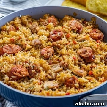 Cooked Chicken and Sausage Jambalaya in pan with toasted french bread on the side