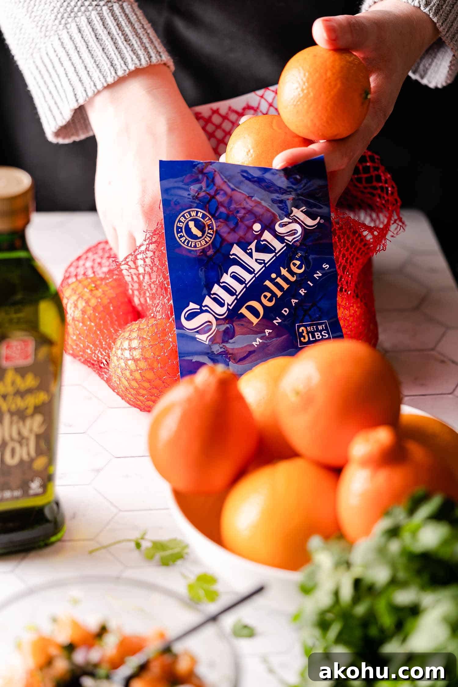 Citrus-Herb Salmon with Orange and Red Onion Salsa 4 hands removing Mandarins from net bag