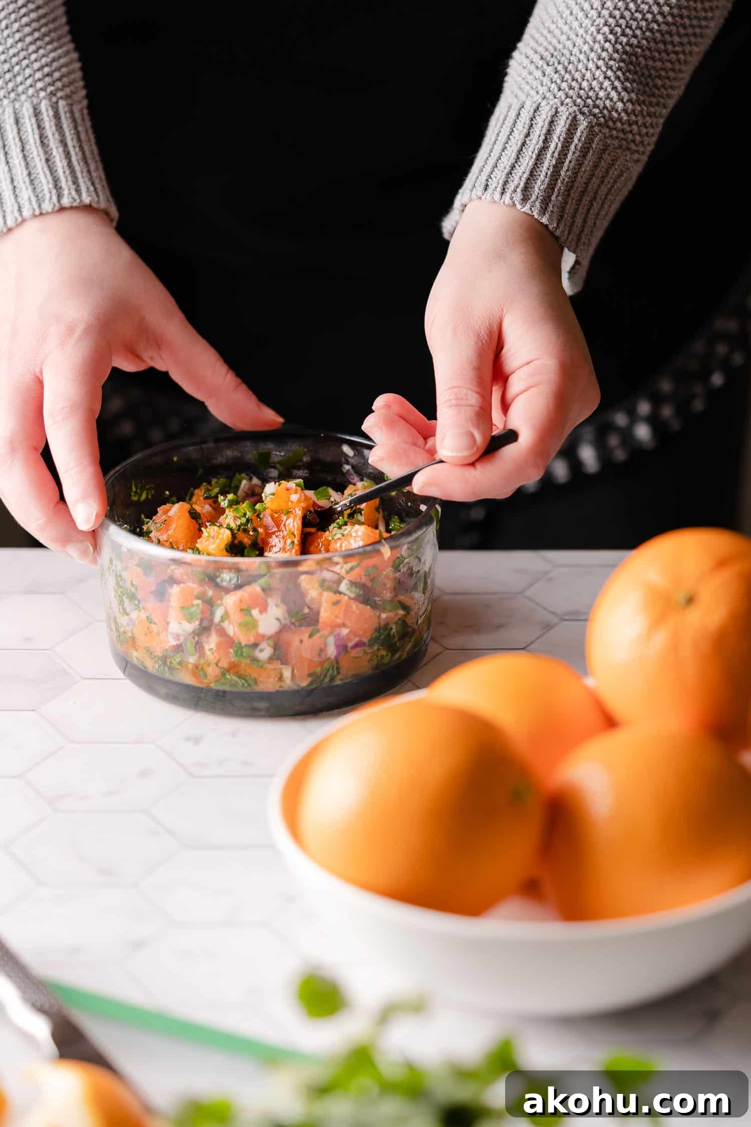 Citrus-Herb Salmon with Orange and Red Onion Salsa 8 Mixing orange red onion salsa in clear bowl