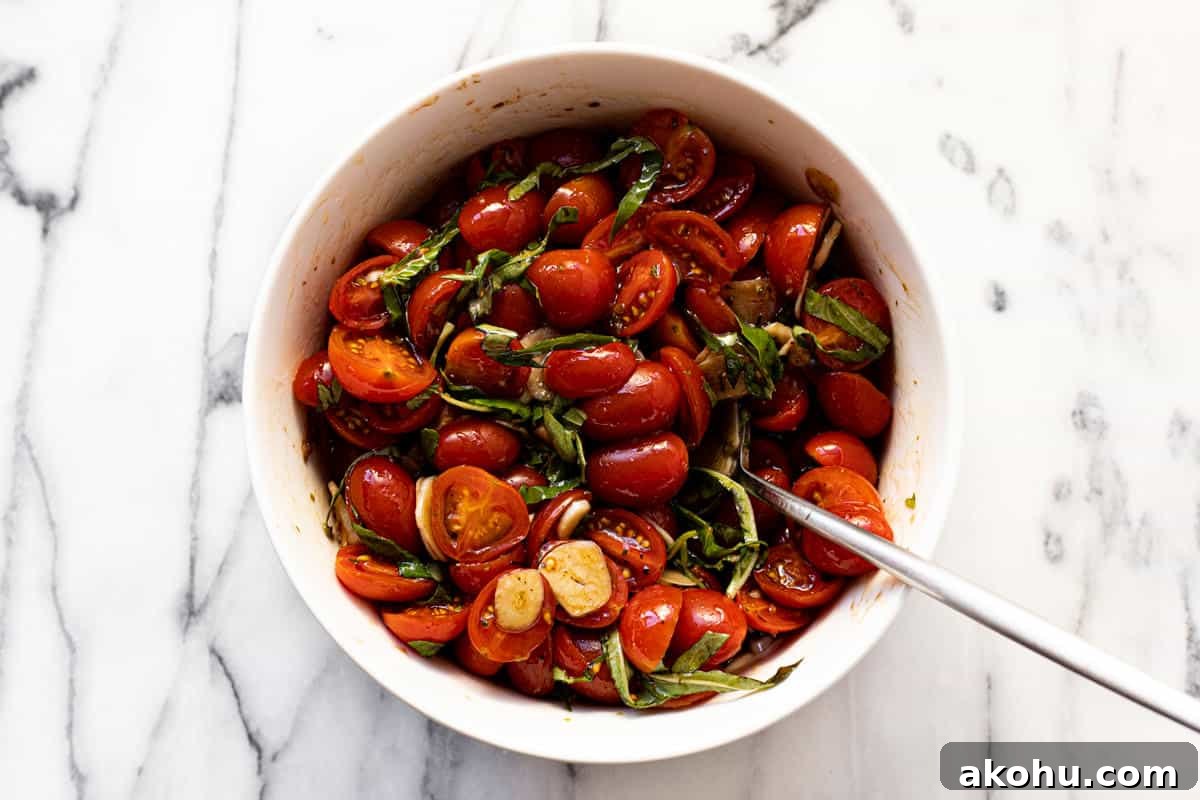 Marinated tomatoes in a white bowl.