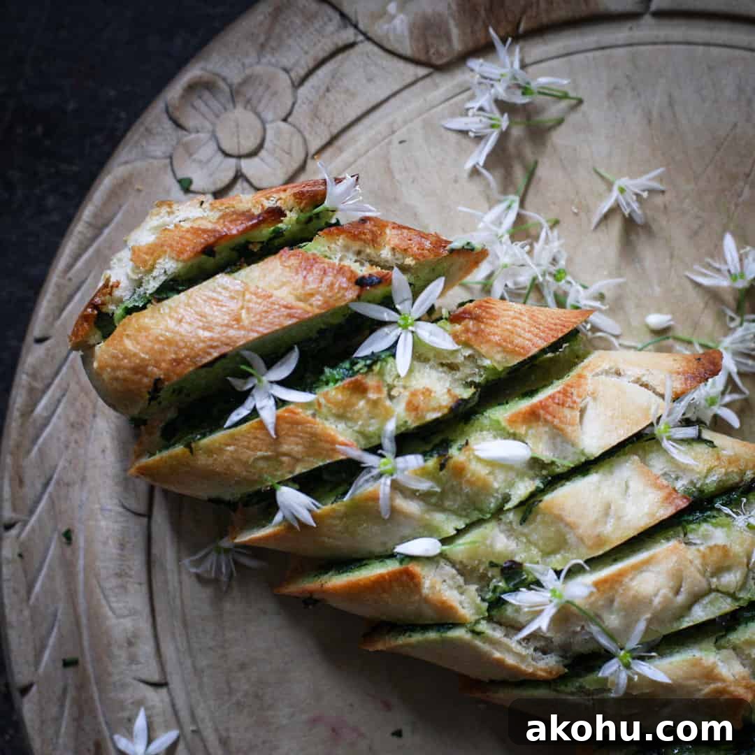Freshly baked golden garlic bread scattered with retry white wild garlic flowers