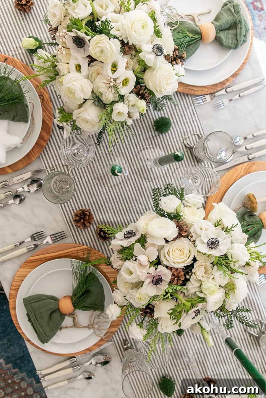 Christmas table decorations with flowers, candles and pine cones.