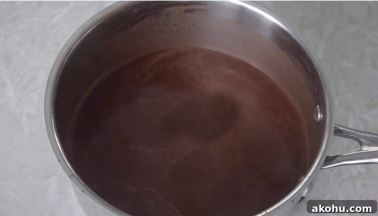 Ultimate Texas Sheet Cake Recipe for Rich Chocolate Dessert 5 Sauce pan of chocolate mixture.