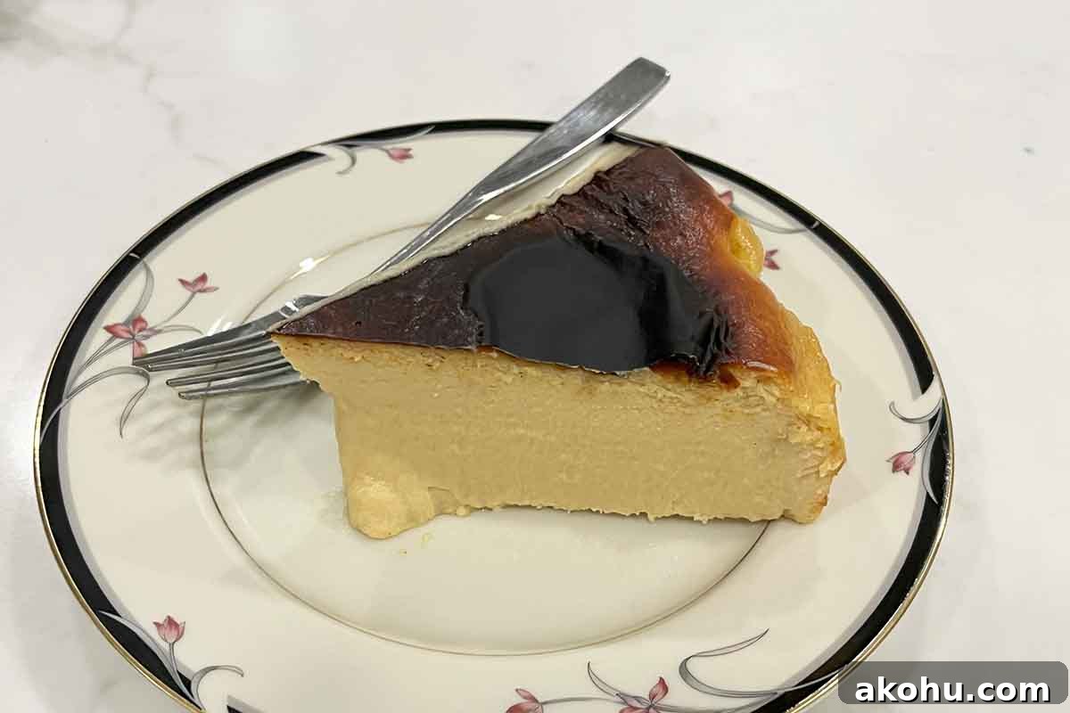 Basque Cheesecake with Tangy Pomegranate Molasses Glaze 21 A slice of pomegranate Basque cheesecake in a plate.