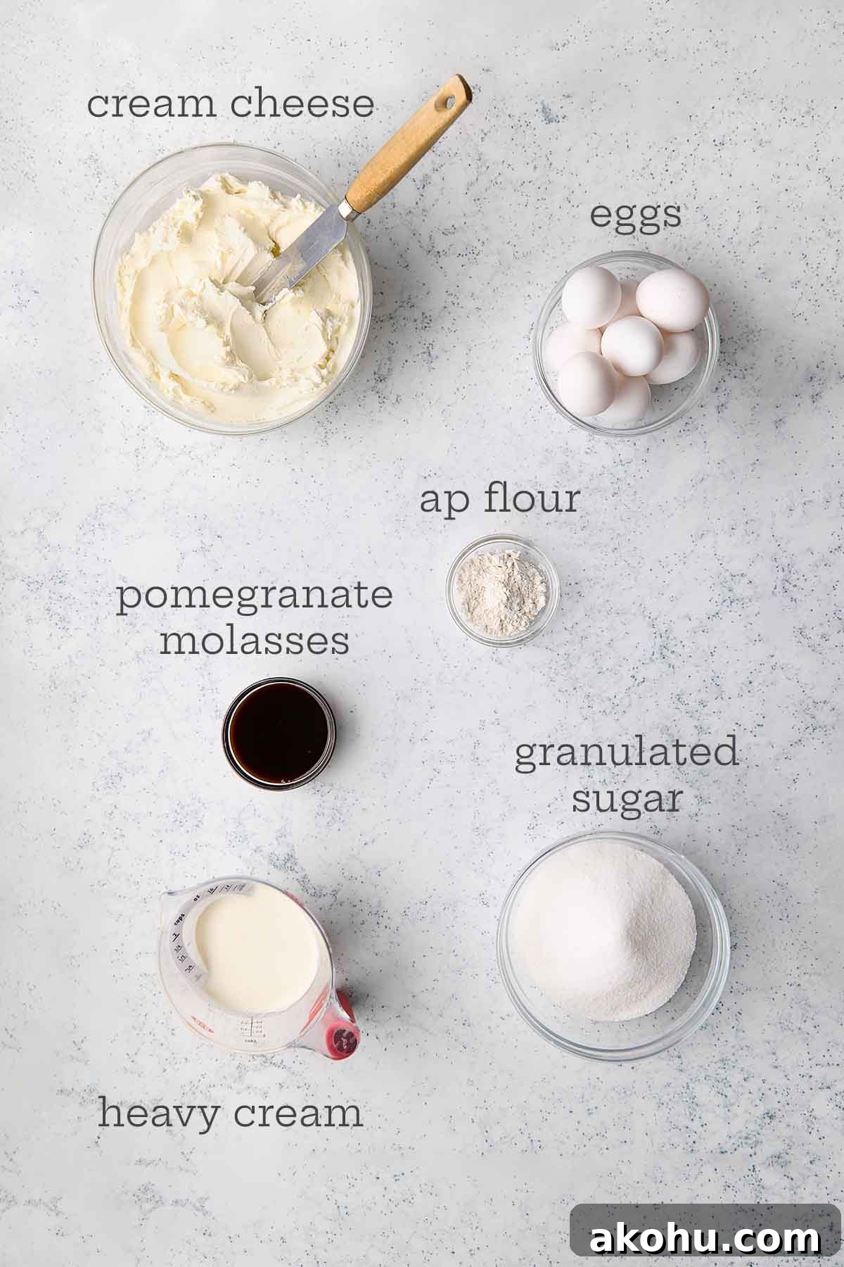 Basque Cheesecake with Tangy Pomegranate Molasses Glaze 6 The ingredients for a pomegranate San Sebastian Basque cheesecake: cream cheese, eggs, all purpose flour, granulated sugar, heavy cream, and pomegranate molasses.