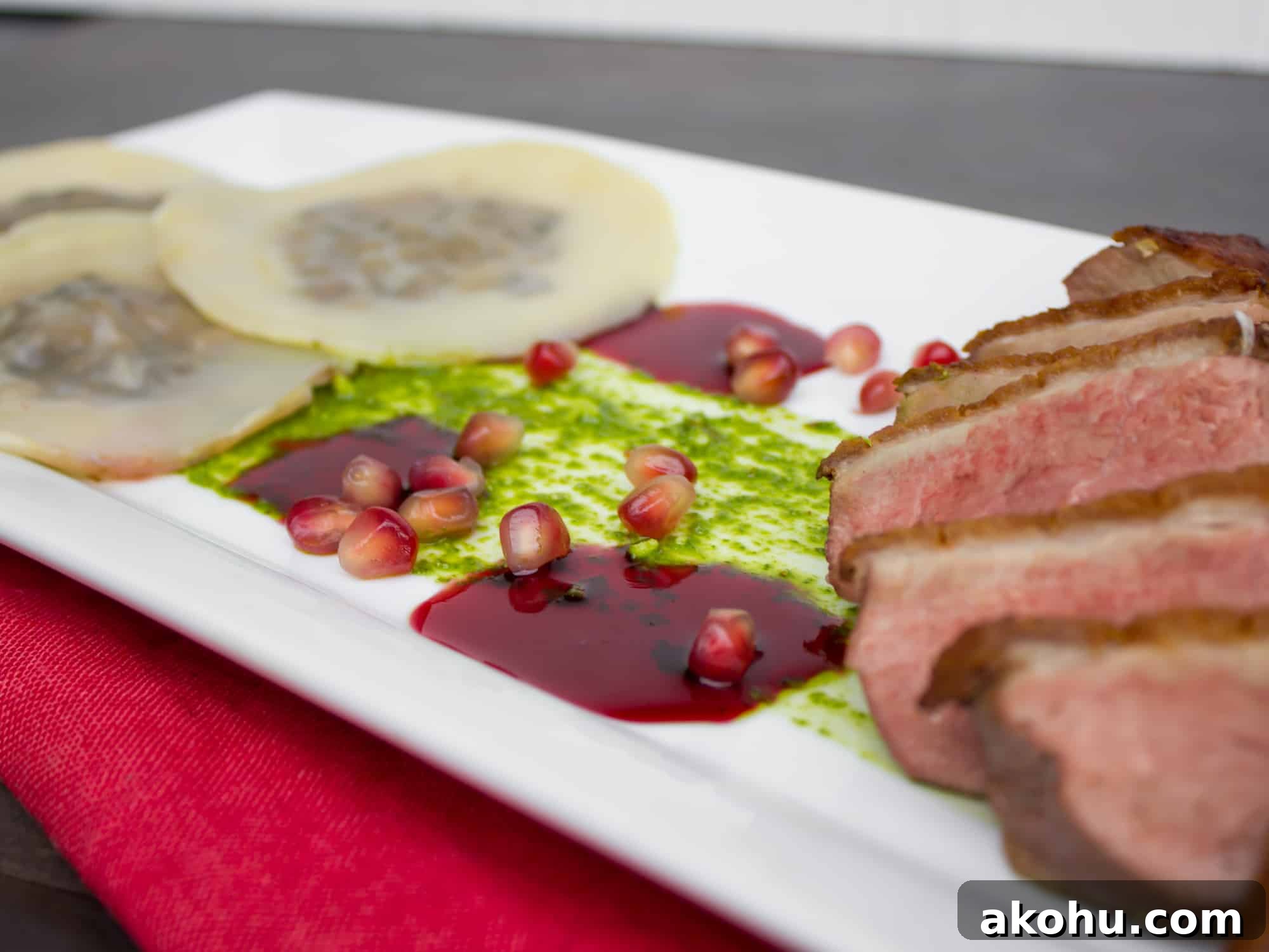 Duck Breast & Cognac Duxelle Wonton Ravioli with Pomegranate Sauce 3 Duck Breast and Cognac Duxelle Wonton Ravioli Recipe with Pomegranate Cognac Sauce and Basil Pesto.