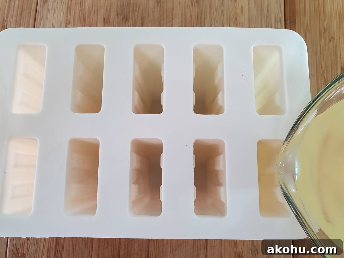 Pouring popsicle mix into popsicle molds.