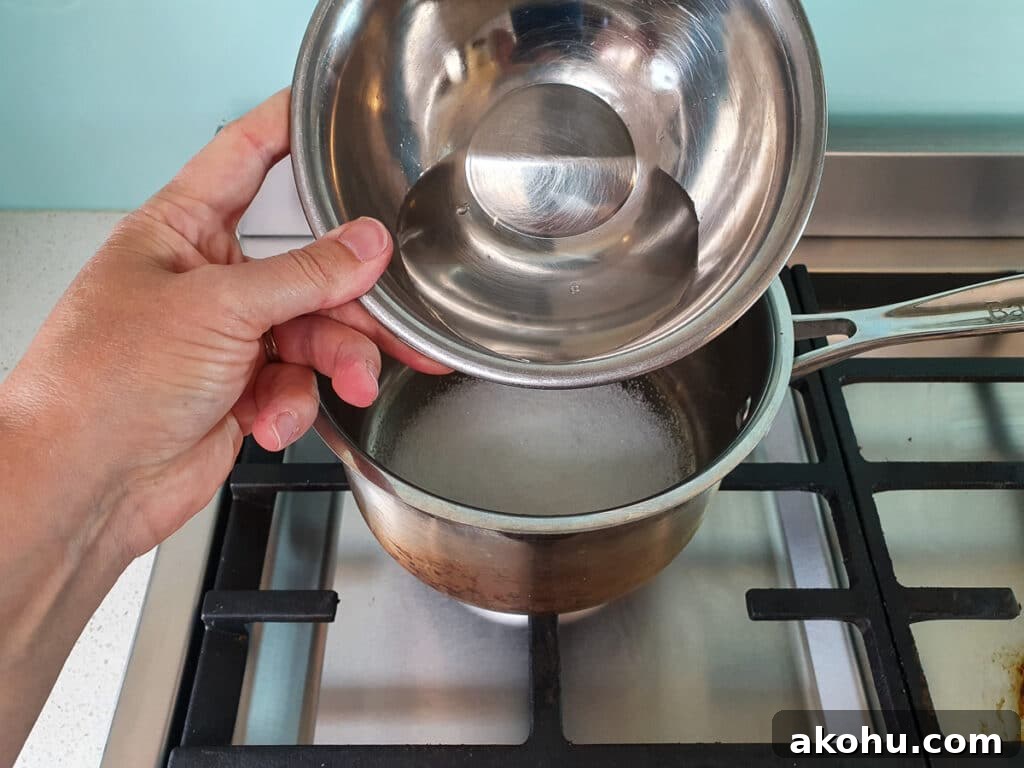 Adding water to pot on stove.
