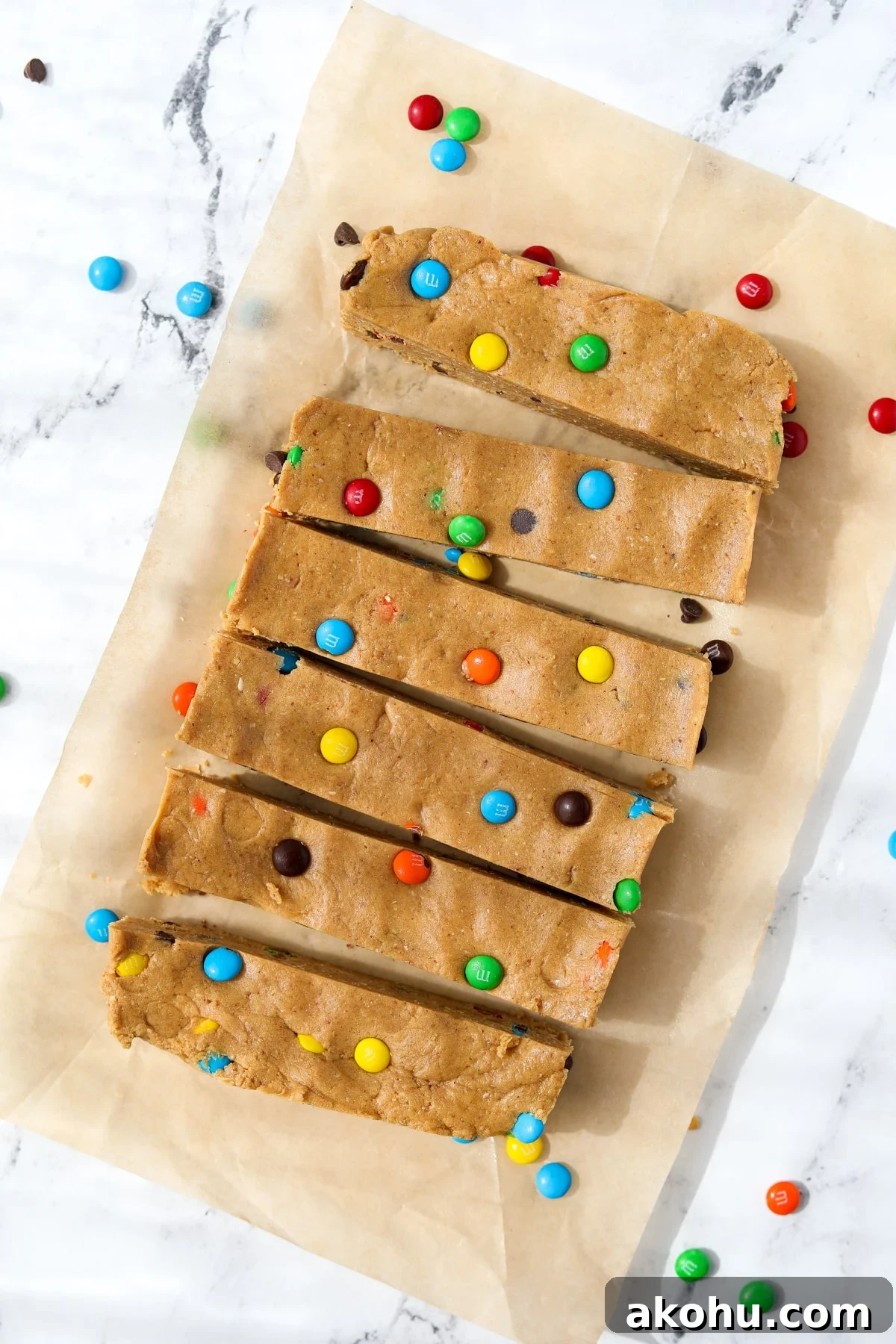 Monster Cookie Protein Bars: Chewy Peanut Butter Oat Bars 2 6 protein bars on a sheet of unbleached parchment paper.