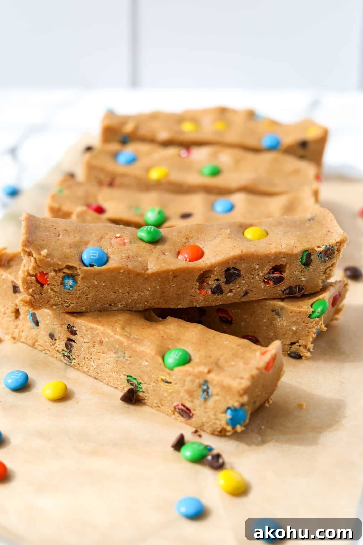 Monster Cookie Protein Bars: Chewy Peanut Butter Oat Bars 12 Protein bars layered on a sheet of parchment paper.