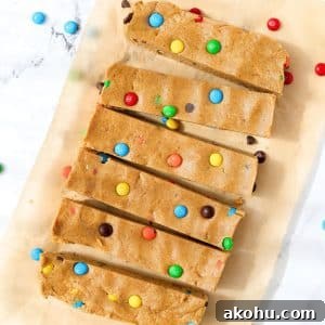 Monster Cookie Protein Bars: Chewy Peanut Butter Oat Bars 14 6 protein bars on a piece of parchment paper, topped with m&m candies.