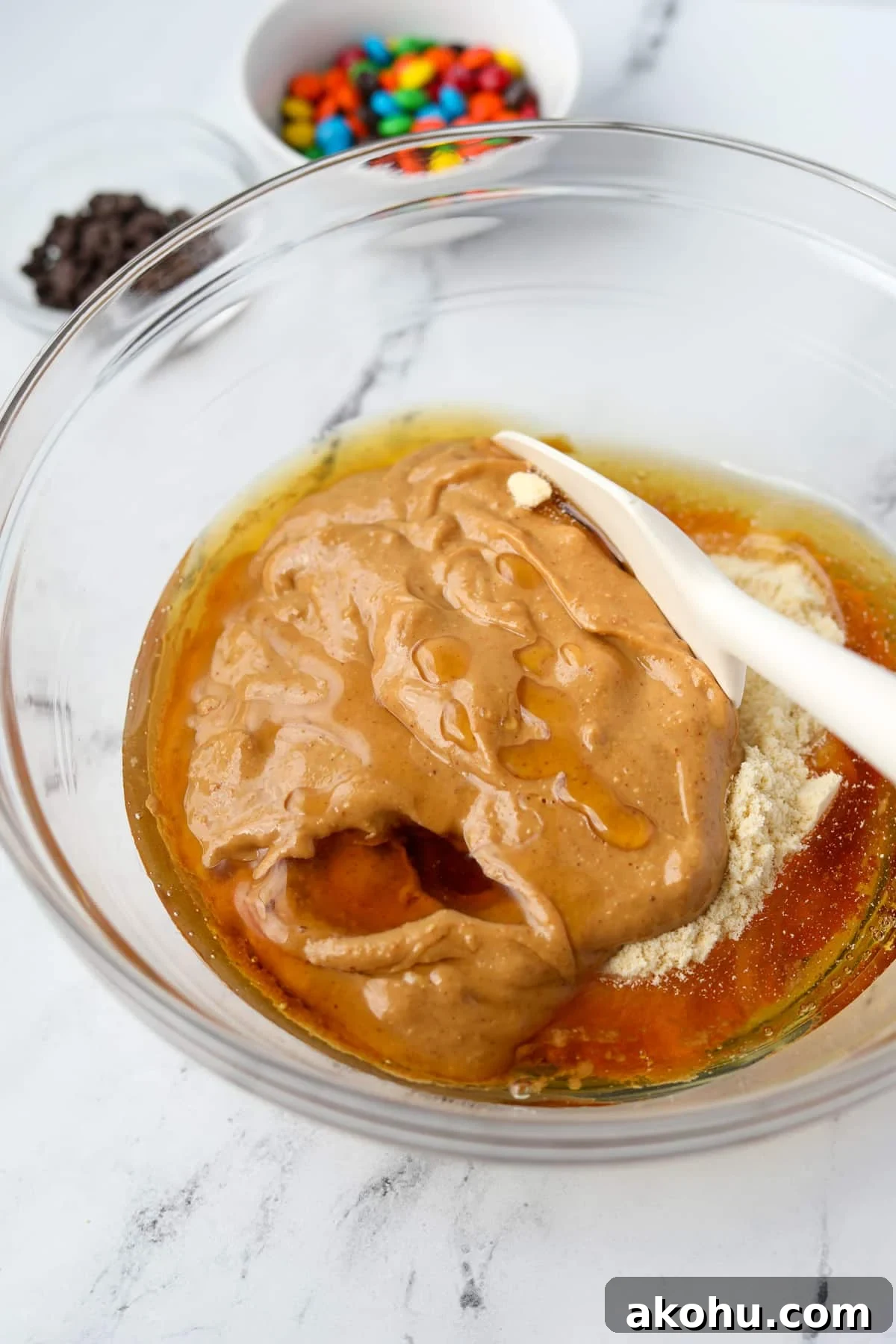 Monster Cookie Protein Bars: Chewy Peanut Butter Oat Bars 5 Stirring together a protein cookie dough.
