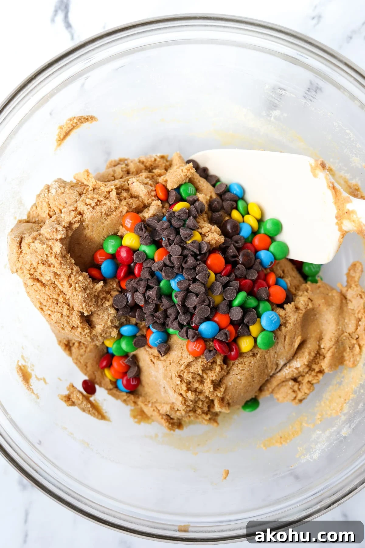 Monster Cookie Protein Bars: Chewy Peanut Butter Oat Bars 7 Adding candies and chocolate to a protein cookie dough.