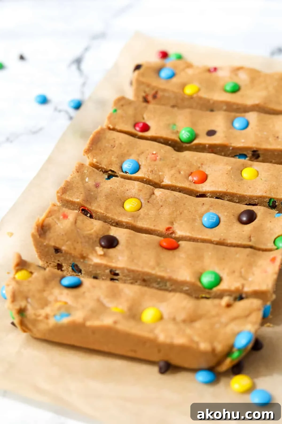 Monster Cookie Protein Bars: Chewy Peanut Butter Oat Bars 10 6 homemade protein bars on a sheet of parchment paper.