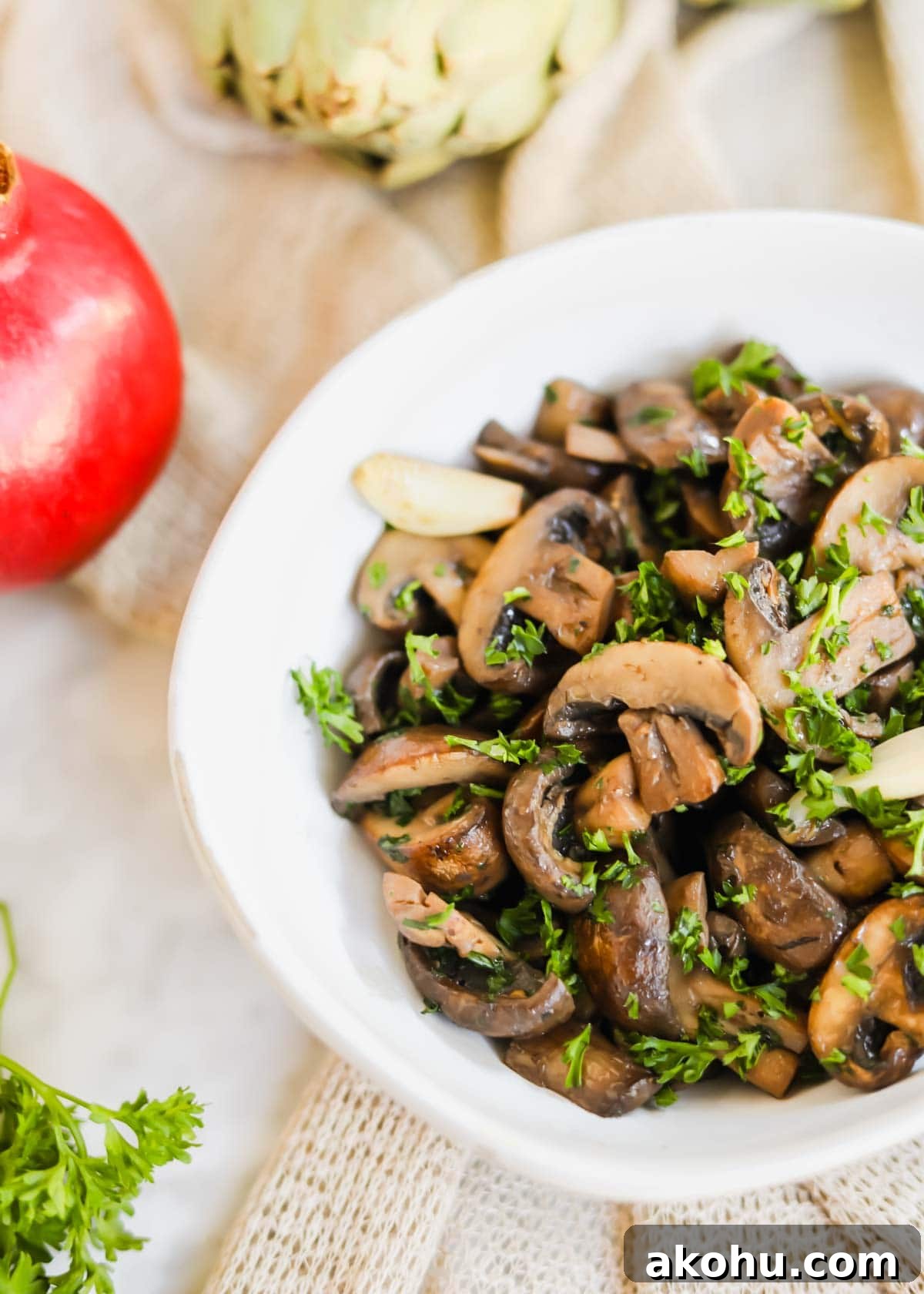 20 Delicious Side Dishes to Serve with Roasted Chicken 11 Sautéed mushrooms with White Wine in white bowl with parsley, garlic, and seasoning.