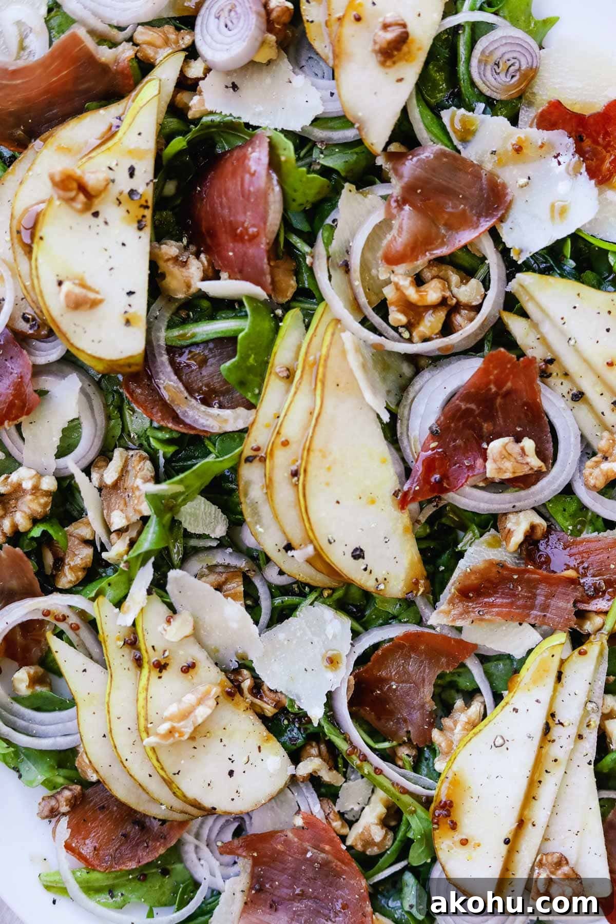 20 Delicious Side Dishes to Serve with Roasted Chicken 18 Closeup shot of arugula salad with pear, crispy prosciutto, shallots, parmigiano-reggiano, and walnuts.