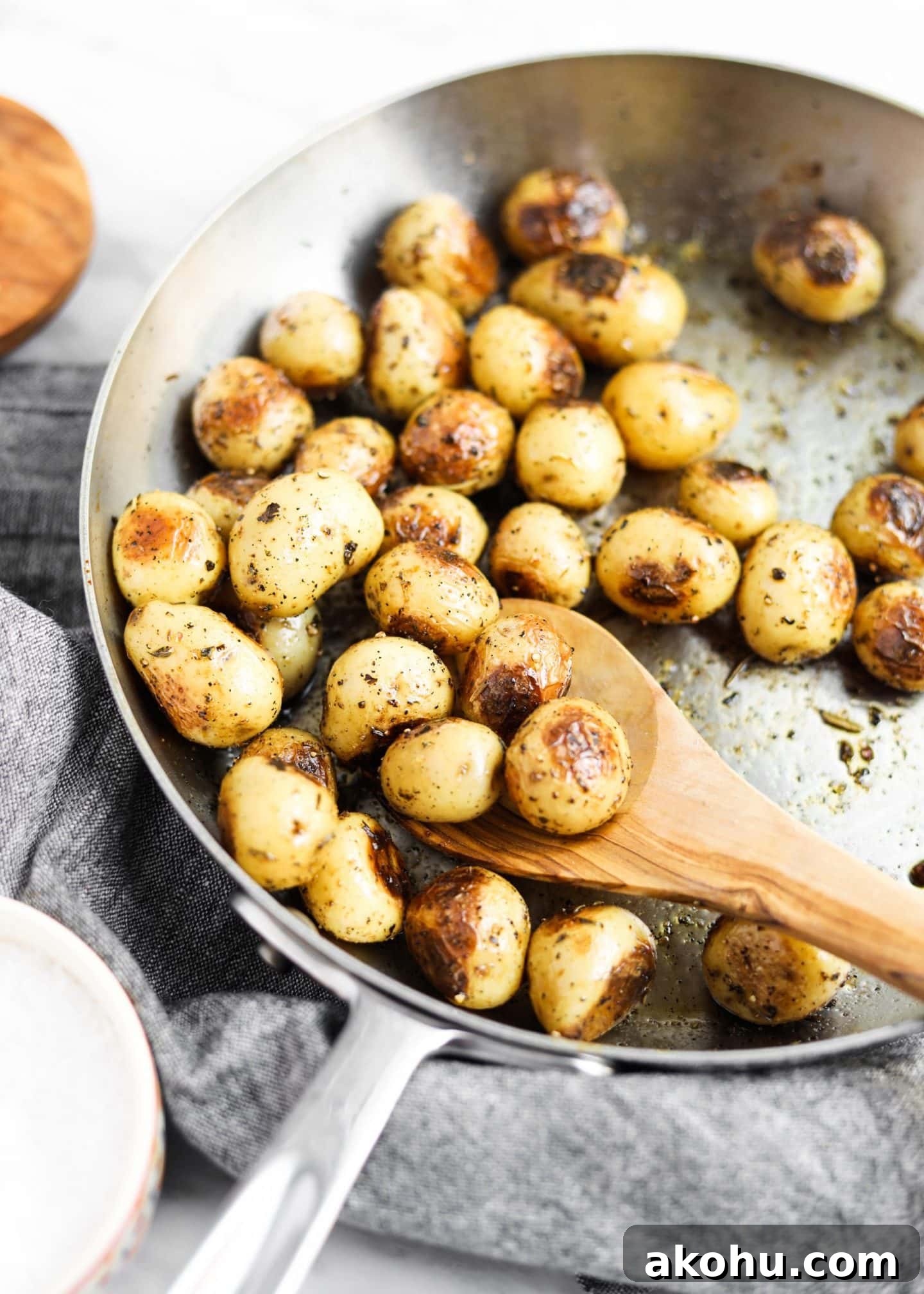 20 Delicious Side Dishes to Serve with Roasted Chicken 3 potatoes roasting in a pan with spoon