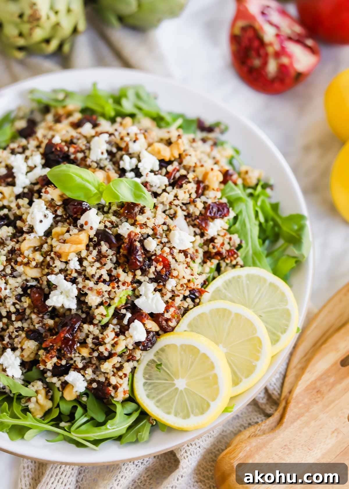 20 Delicious Side Dishes to Serve with Roasted Chicken 22 Harvest Salad with Quinoa and Arugula and lemon slices on plate.