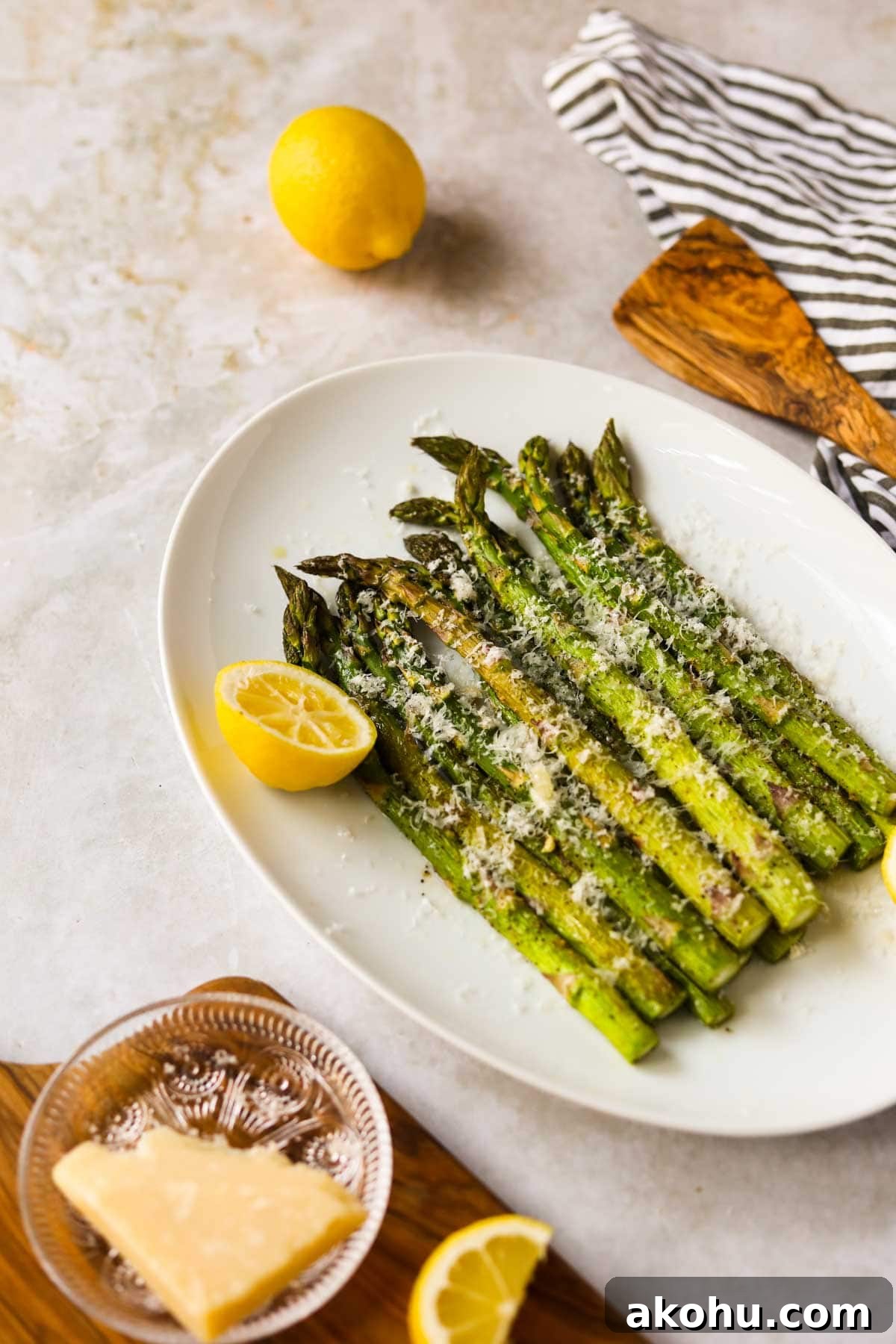 20 Delicious Side Dishes to Serve with Roasted Chicken 5 Roasted Asparagus with Parmesan and Lemon on plate.