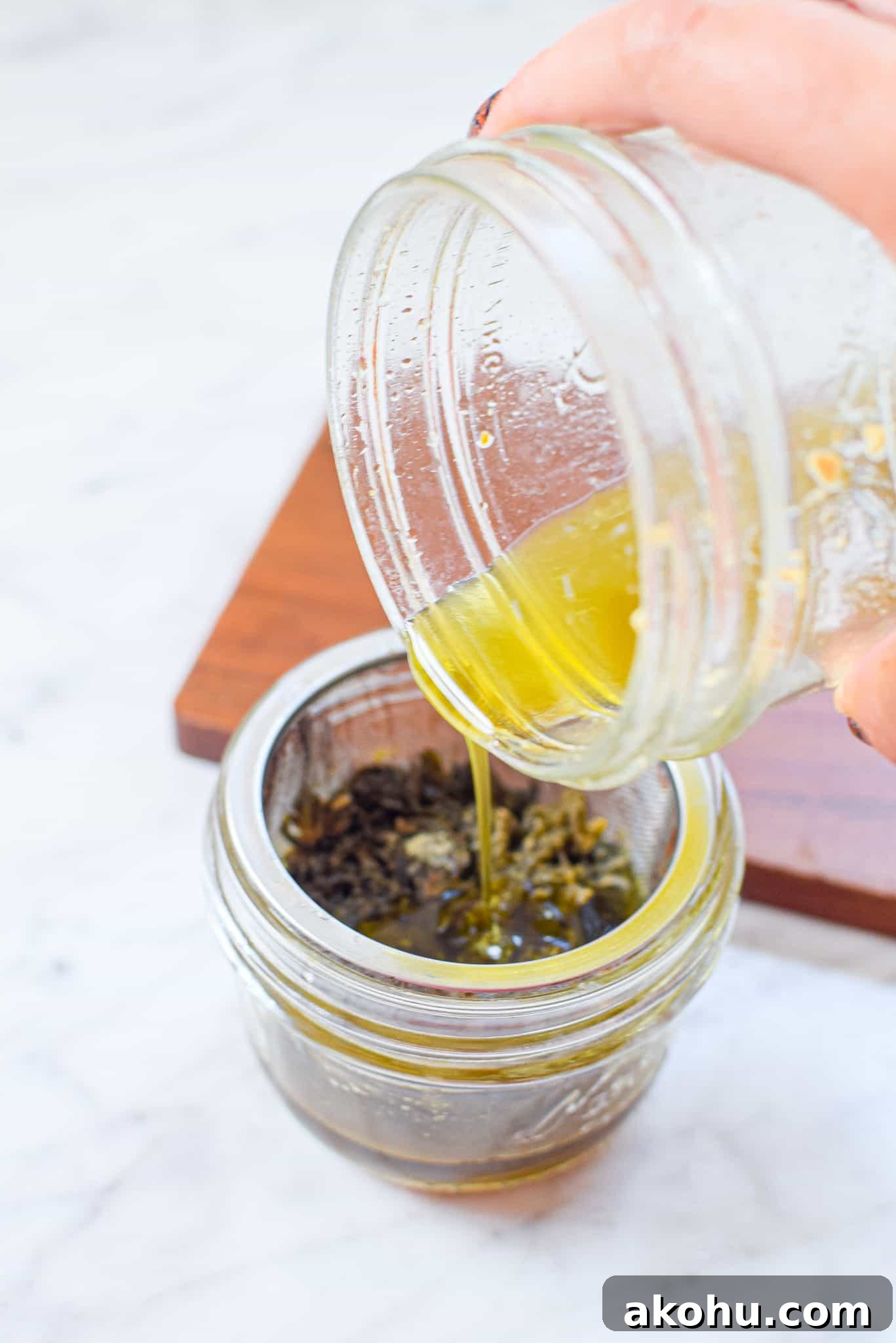 A picture of cannabutter being poured into a mason jar. 