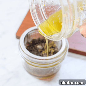 A picture of cannabutter being poured into a mason jar.