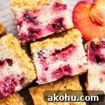 Classic Plum Cake Recipe: Moist, Fragrant Holiday Dessert 15 Slices of plum cake with streusel on a platte with a half plum nearby.