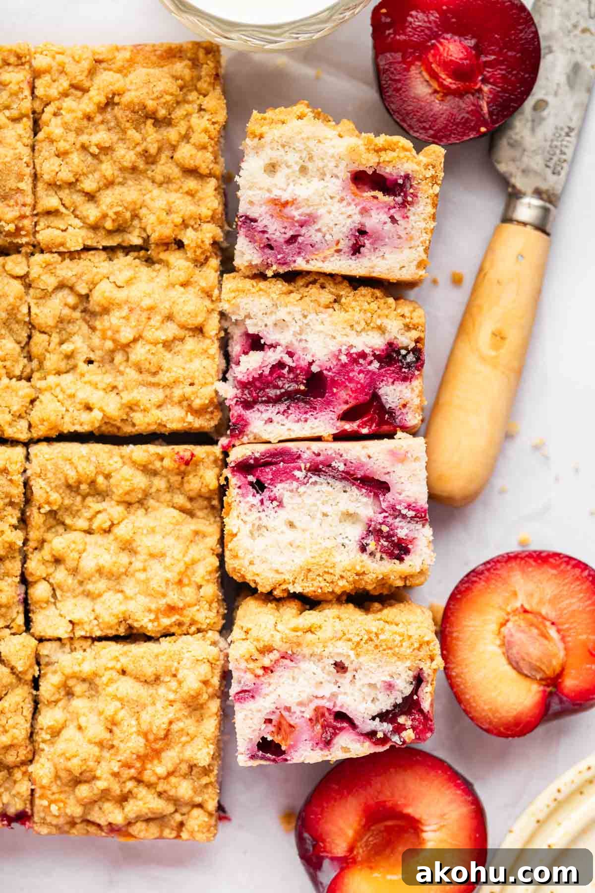 Classic Plum Cake Recipe: Moist, Fragrant Holiday Dessert 5 Overhead shot of plum cake with slices laying on side to show fruit bits in the cake.