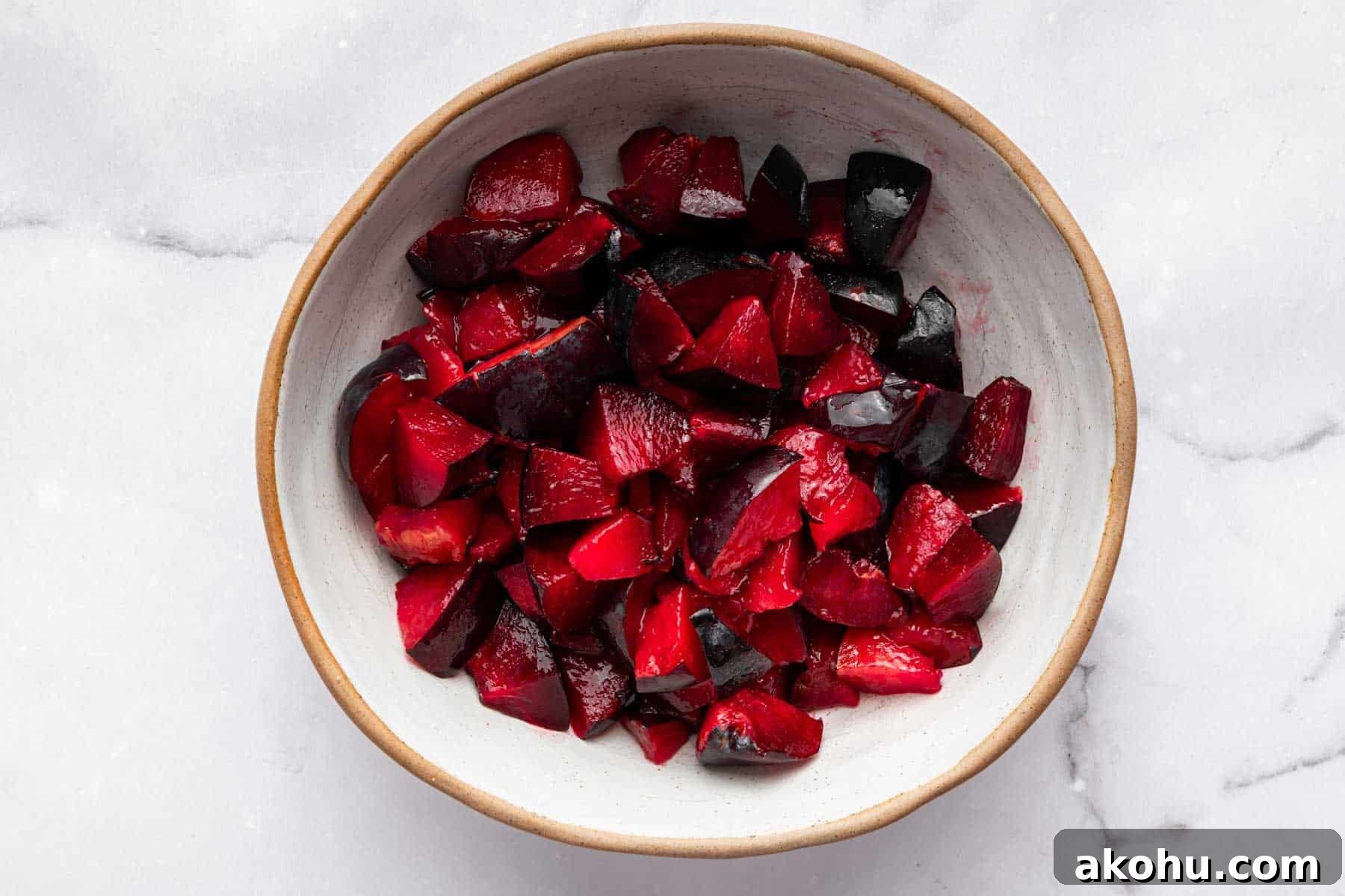Classic Plum Cake Recipe: Moist, Fragrant Holiday Dessert 8 Bowl of Santa Rosa plums sliced in a white bowl.