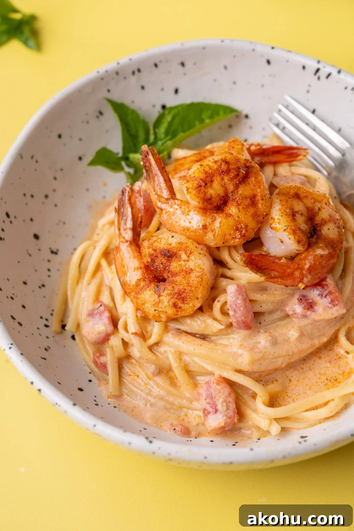 30-Min Cajun Creamy Shrimp Pasta Recipe 2 Close up of creamy Cajun shrimp pasta cropped with fork in it.