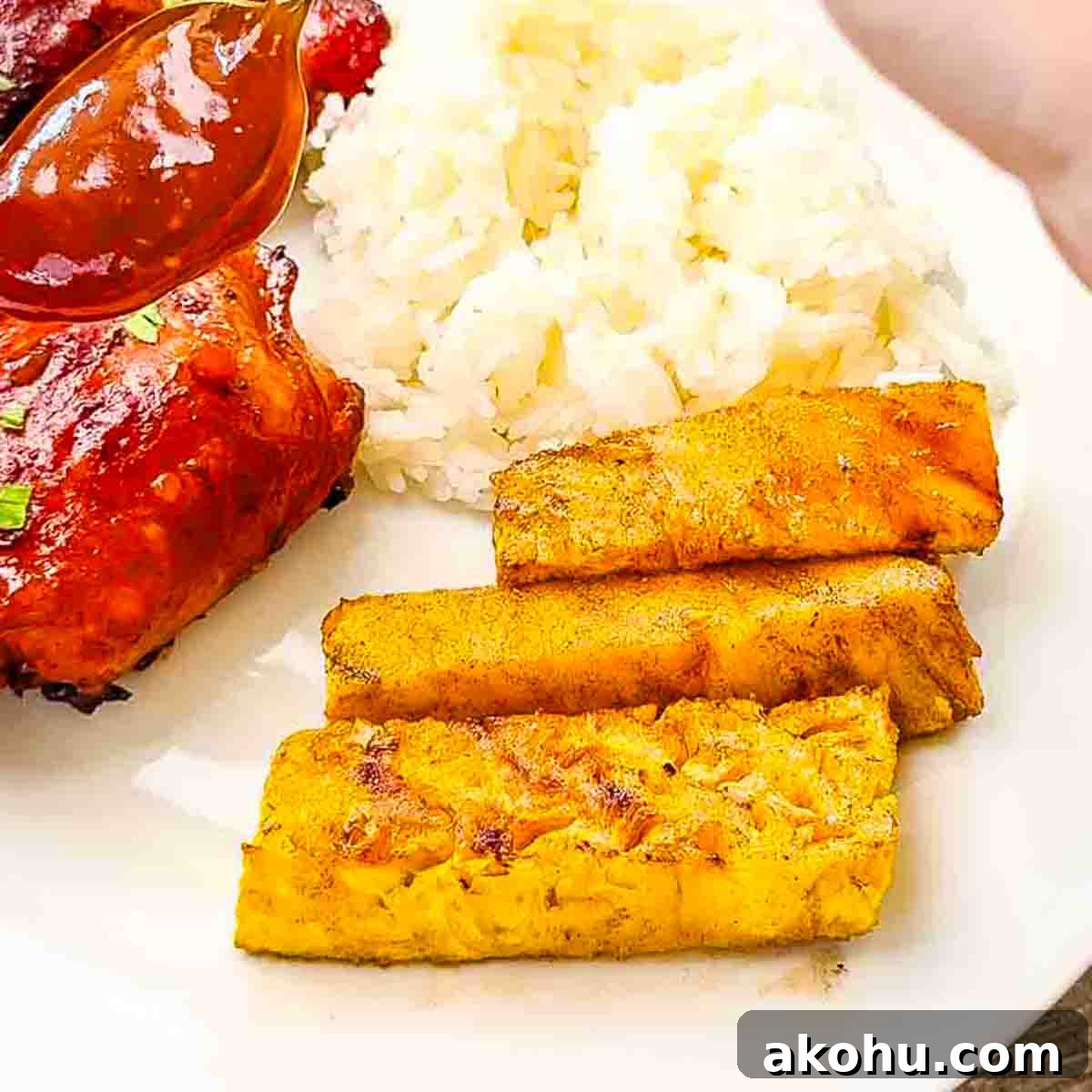 Smoked pineapple spears on a plate, ready to be enjoyed as a sweet and smoky side dish.