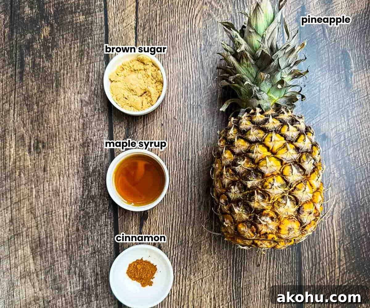 Ingredients for smoked pineapple, including a whole pineapple, brown sugar, maple syrup, and ground cinnamon, arranged on a kitchen counter.