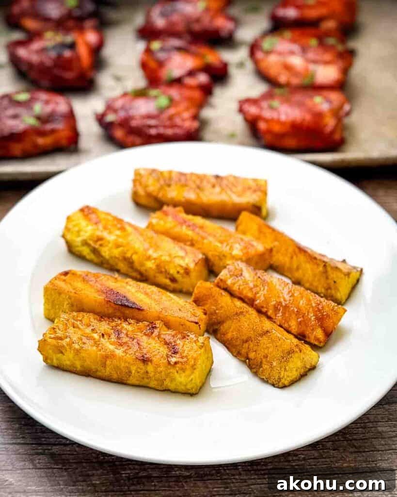 Smoked pineapple spears removed from the smoker and placed on a serving platter.