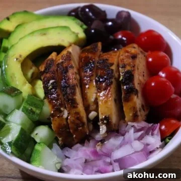 grilled chicken salad served in a bowl.