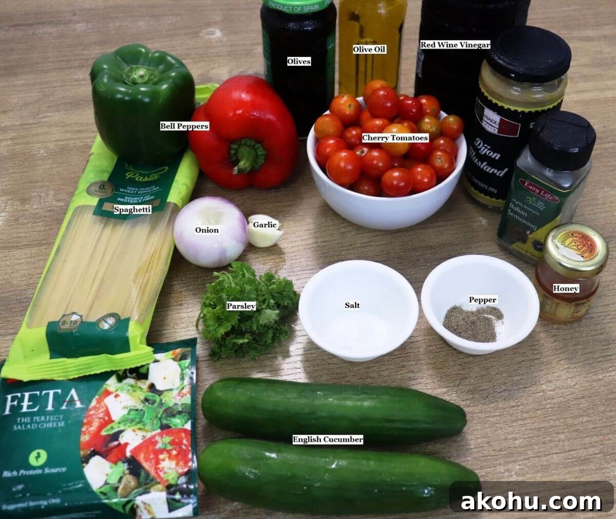 individually labeled ingredients to make spaghetti salad with chicken are laid out on a table.
