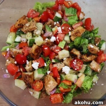Mediterranean chicken salad in a glass bowl.
