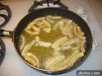 Crispy Fried Calamari (Kalamarakia Tiganita) Recipe 2 Squid frying in lots of oil.