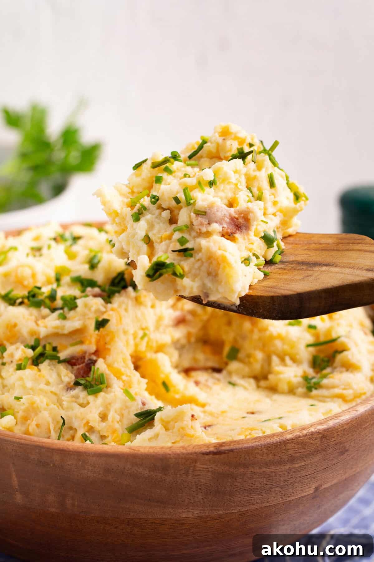 Ultimate Loaded Mashed Potatoes Recipe: Creamy, Cheesy Comfort Side 7 loaded mashed potatoes sitting on a wooden spatula