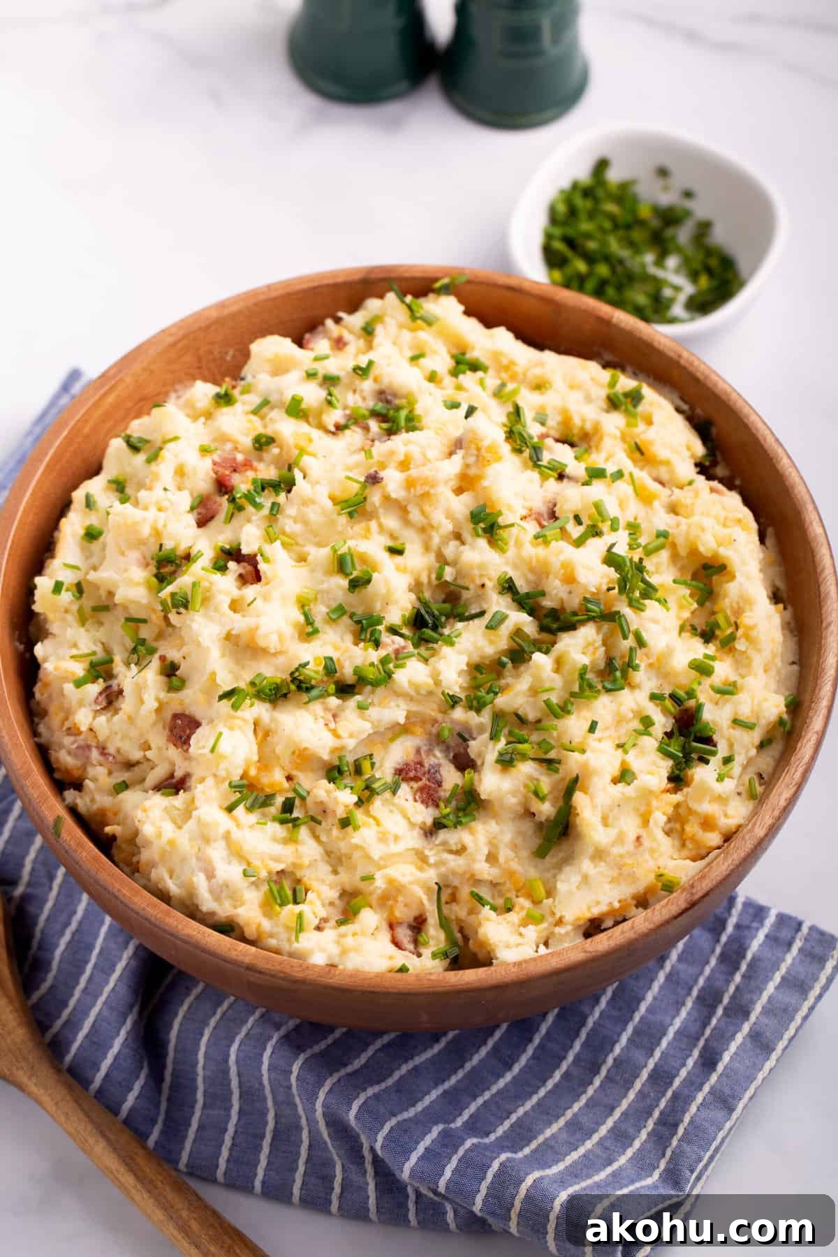 Ultimate Loaded Mashed Potatoes Recipe: Creamy, Cheesy Comfort Side 3 top down image of a wooden bowl full of loaded mashed potatoes