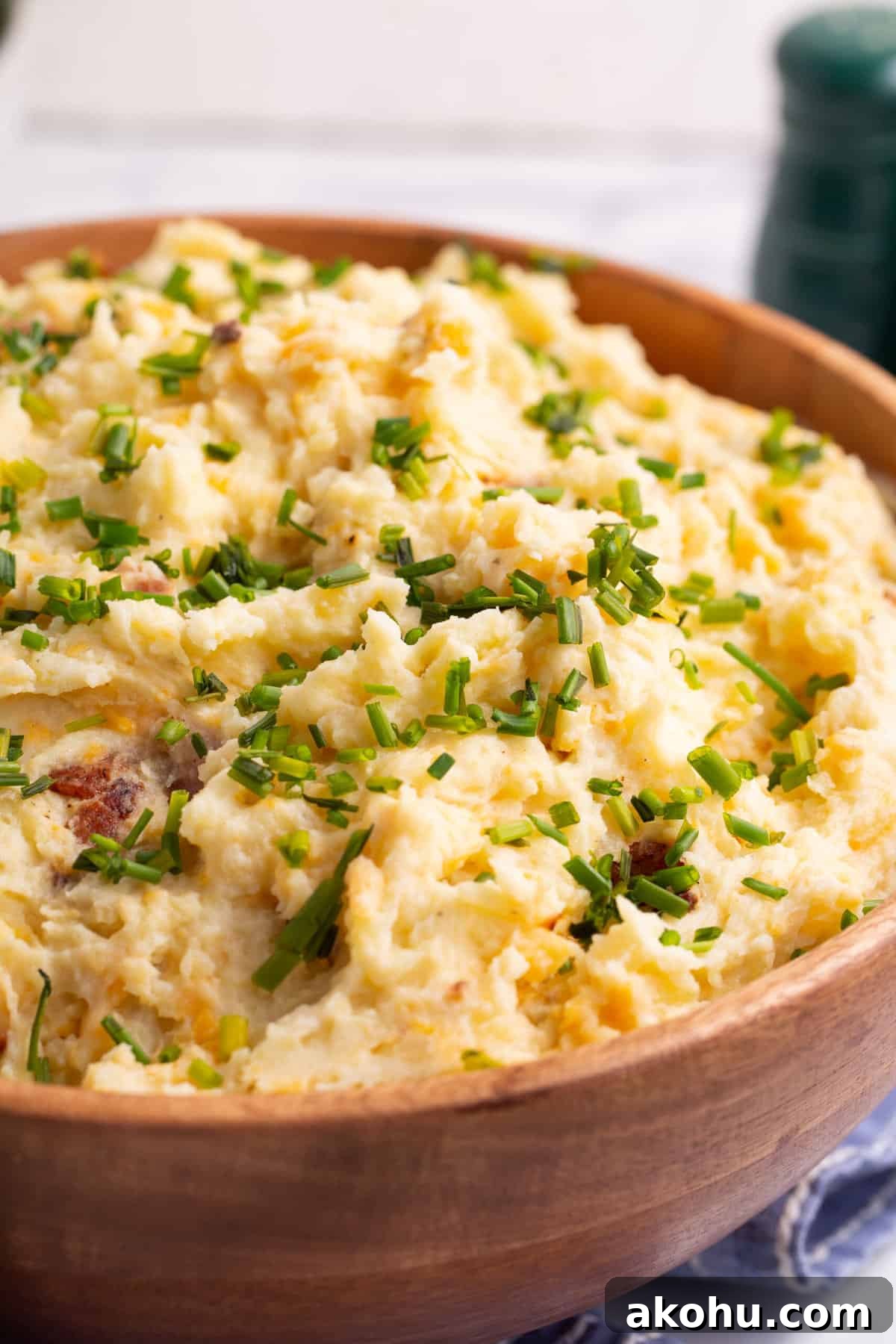 Ultimate Loaded Mashed Potatoes Recipe: Creamy, Cheesy Comfort Side 6 close up image of a wooden bowl full of loaded mashed potatoes