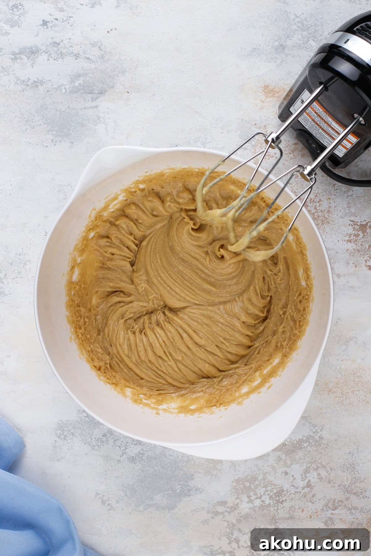 Chocolate Chip Cookie Cake Recipe — Soft, Gooey Dessert King 6 Wet ingredients for chocolate chip cookie cake mixed in a white bowl.