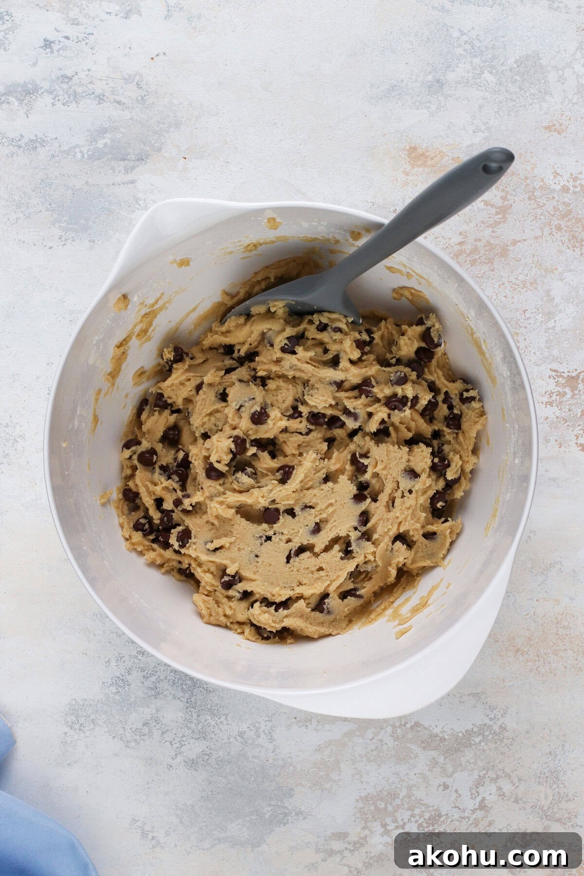 Chocolate Chip Cookie Cake Recipe — Soft, Gooey Dessert King 8 Cookie dough for cookie cake in a white bowl.