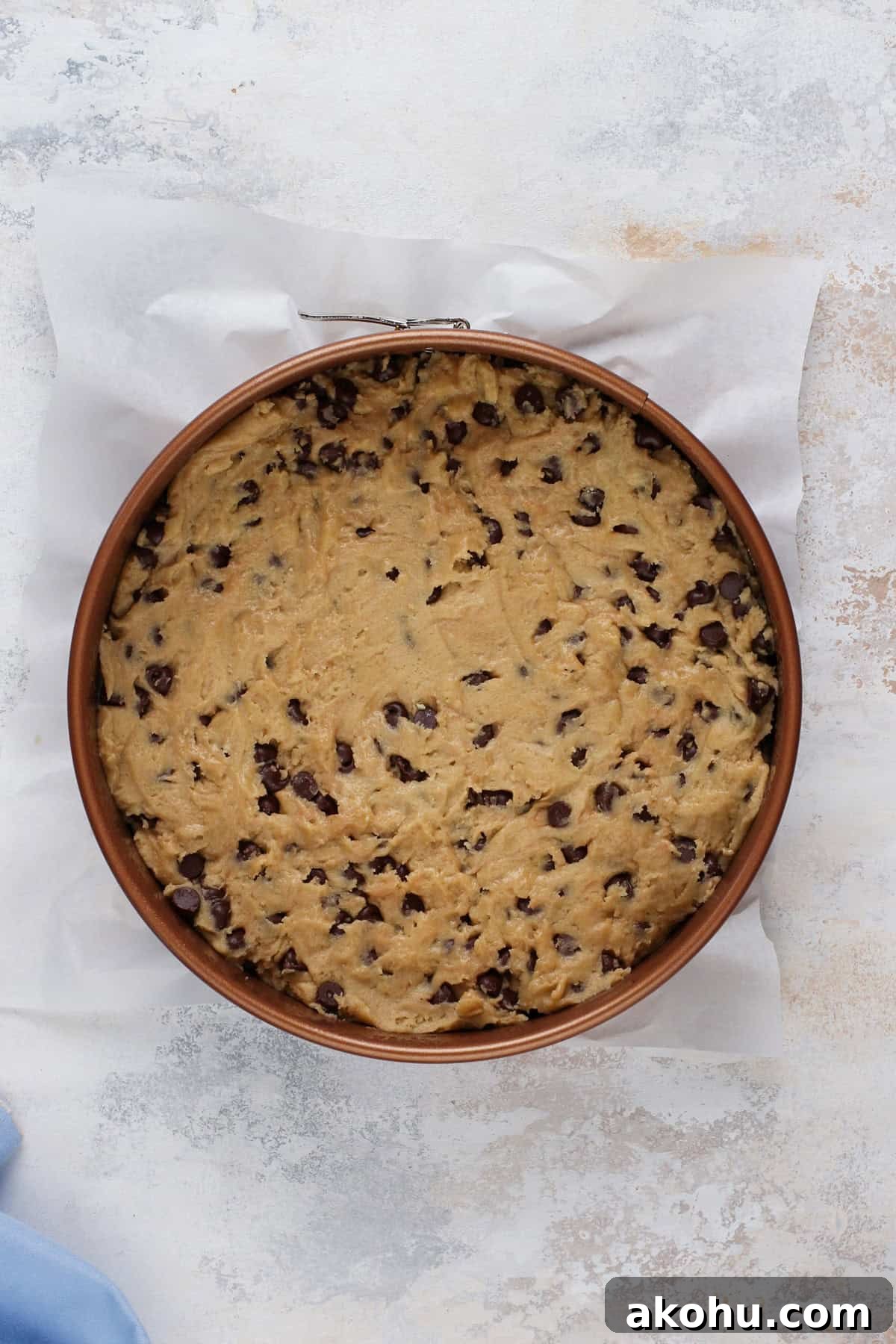 Chocolate Chip Cookie Cake Recipe — Soft, Gooey Dessert King 9 Unbaked chocolate chip cookie cake in a springform pan, ready to go in the oven.